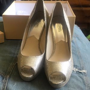 Woman’s silver Michael Kors York Platform heels.